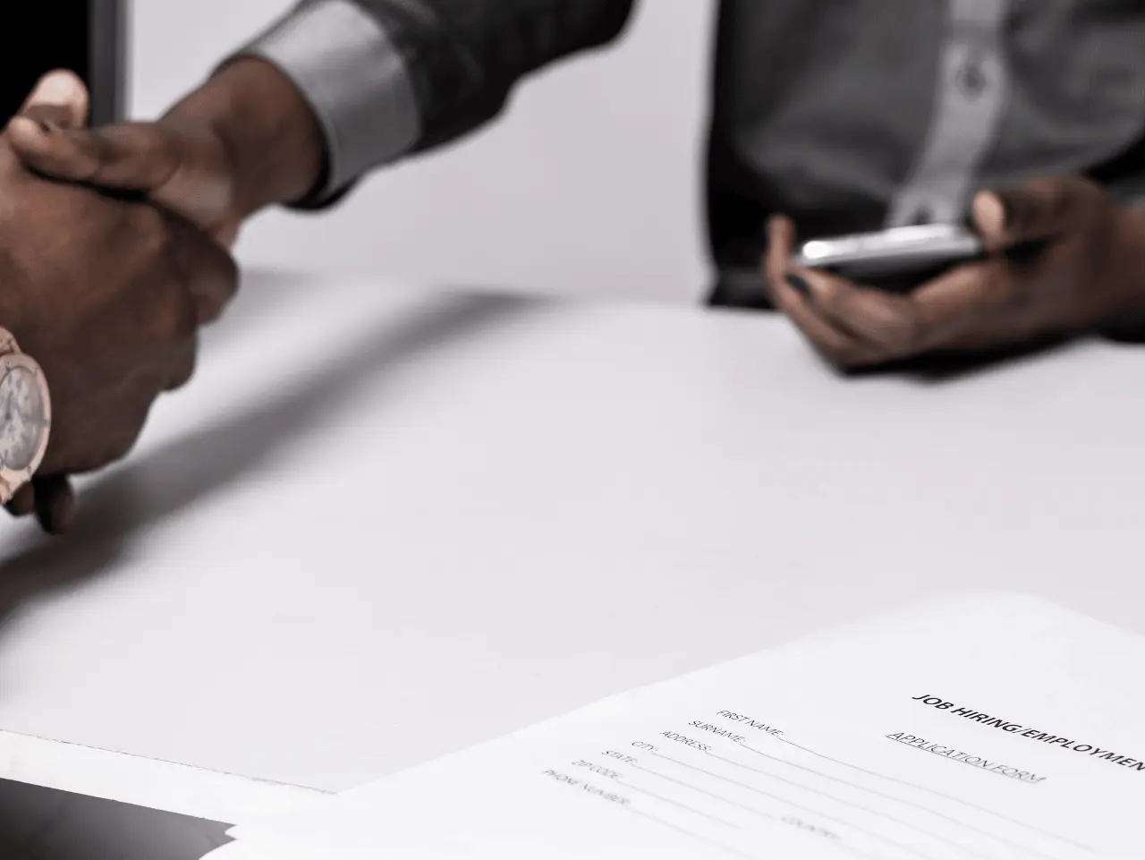 Kazicloud_A professional office setting featuring a confident executive shaking hands with a recruiter, symbolizing Executive Search